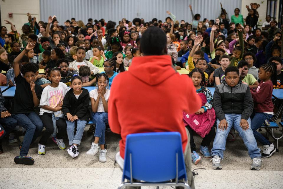 Kansas City Chiefs football player and Fayetteville native Joshua Williams takes questions from students at Loyd Auman Elementary School on Thursday, March 2, 2023. Williams read a Dr. Suess book, shared his Super Bowl experiences and answered student questions during the visit.  