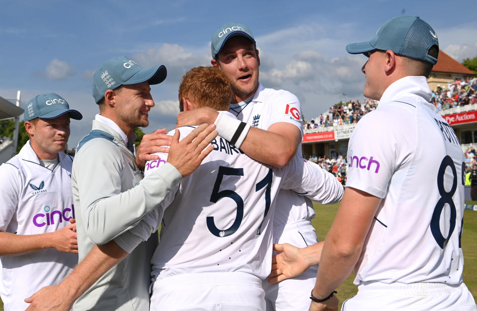 England batsman Jonny Bairstow (pictured middle) embraced by is teammates.