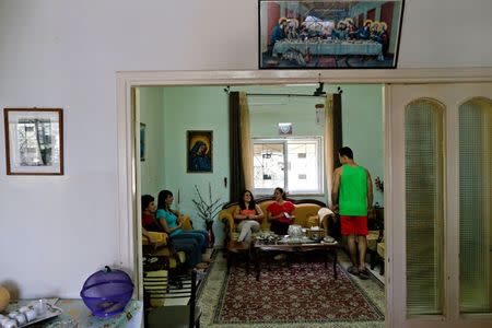 Palestinian swimmer Mary Al-Atrash (2nd L), 22, who will represent Palestine at the 2016 Rio Olympics, sits with her family in Beit Sahour, near the West Bank town of Bethlehem June 27, 2016. REUTERS/Ammar Awad