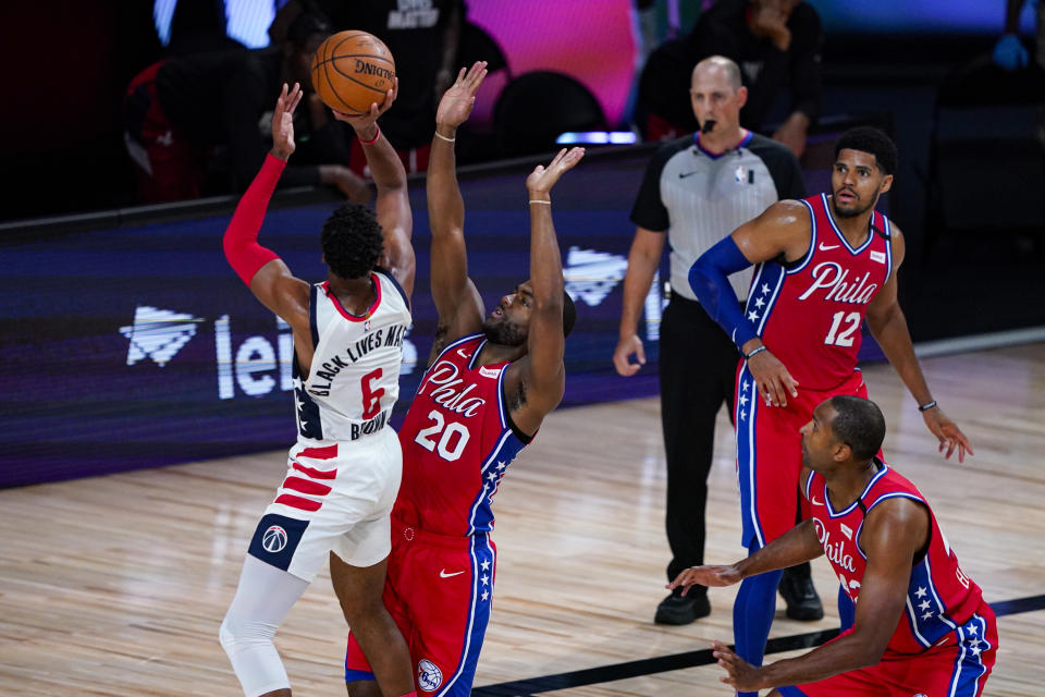 Washington Wizards forward Troy Brown Jr. (6) shoots over Washington Wizards guard Gary Payton II (20) during the second half of an NBA basketball game Wednesday, Aug. 5, 2020 in Lake Buena Vista, Fla. (AP Photo/Ashley Landis)