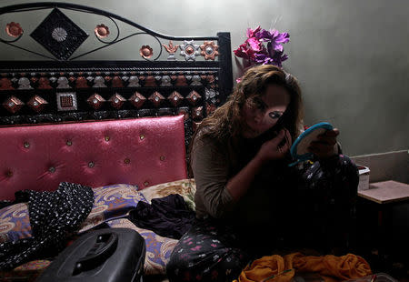 Farzana Jan, a member of the transgender community, applies make up as she prepares for Shakeela's party in Peshawar, Pakistan January 22, 2017. REUTERS/Caren Firouz