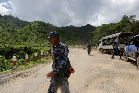 Police guard near a bridge after Arakan Rohingya Salvation Army (ARSA) attacked, in Buthidaung, Myanmar August 28, 2017. REUTERS/Soe Zeya Tun/Files