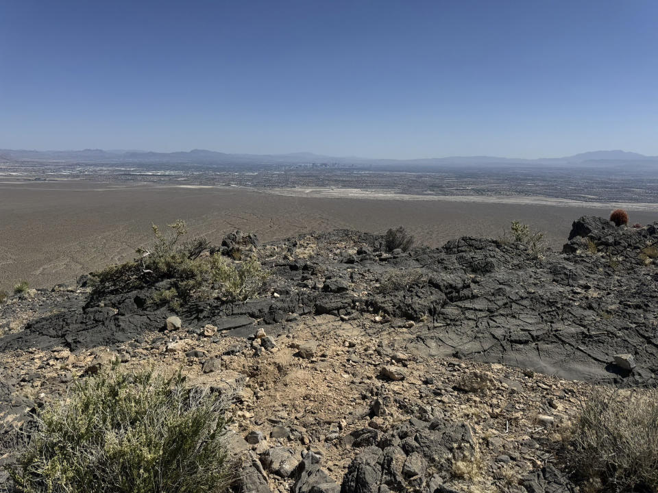 This photo provided by Las Vegas Metropolitan Police Department, the mysterious Monolith is removed on Thursday, June 20, 2024 in Gass Peak, part of the vast Desert National Wildlife Refuge in Nevada. A strange monolith found jutting out of the rocks in a remote mountain range near Las Vegas has been taken down by authorities. (Las Vegas Metropolitan Police Department via AP)