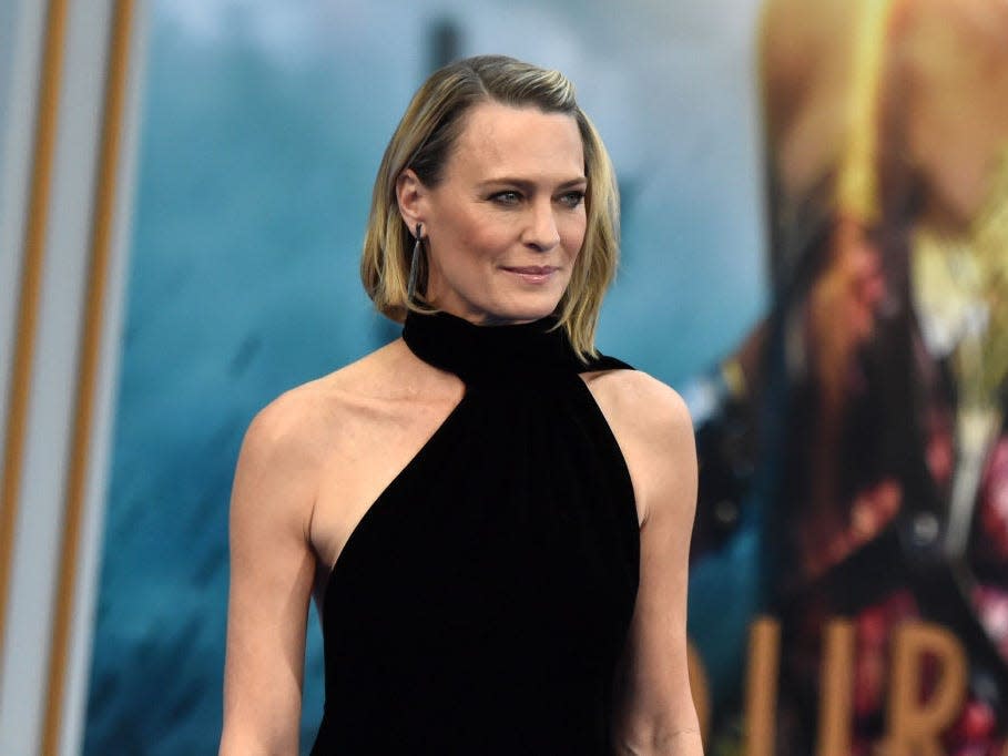 Robin Wright at an event wearing a black halter dress