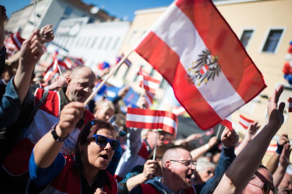 Supporters of Austria's right-wing FPOe political party wave an Austrian flag during the final campaign rally before European parliamentary elections on May 25, 2019, in Vienna (Getty Images)