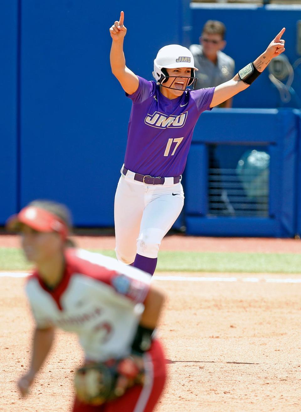 James Madison's Kate Gordon (17) celebrates her home run in the eighth inning against Oklahoma in Game 1 of the Women's College World Series.