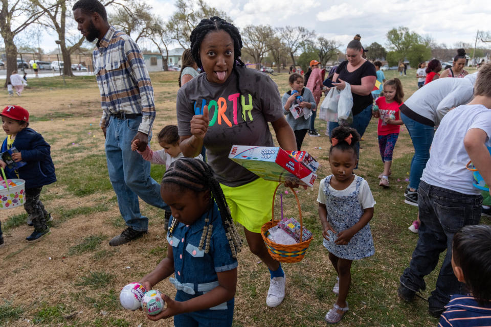 A  family collects their toys as rain starts to fall during  Shi Lee's 7th annual Citywide Easter Egg Hunt  Sunday at Bones Hooks Park in Amarillo.
