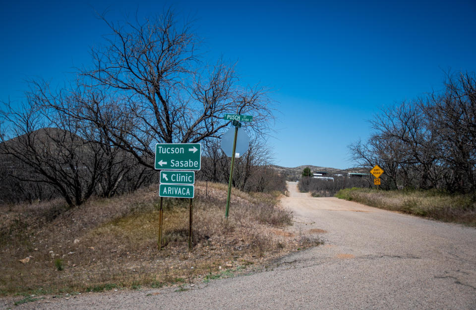 A sign for the only medical clinic in Arivaca marks a junction at the end of town. (Photo: Eli Imadali for HuffPost)