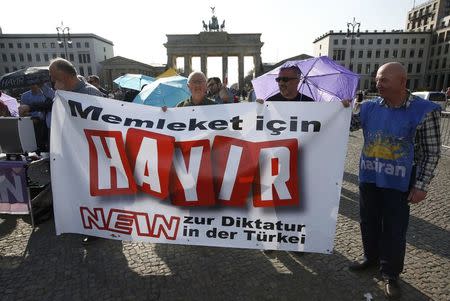 People hold a banner calling Turkish voters to vote "no" on the upcoming referendum as they attend an anti-Turkish President Tayyip Erdogan prostest in front of the Brandenburg Gate in Berlin, Germany, April 1, 2017. REUTERS/Fabrizio Bensch