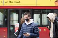 A man wears a protective mask as he walks on Oxford Street in London