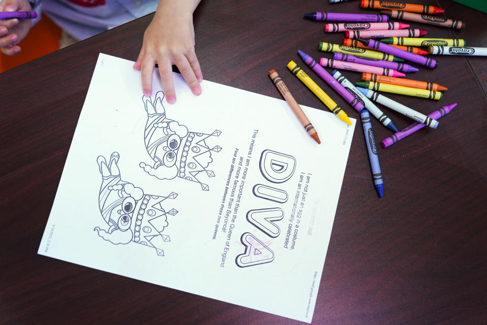 Crayons are available for kids to color worksheets with while attending a Drag Story Hour at a public library in New York, Friday, June 17, 2022. (AP Photo/Seth Wenig)