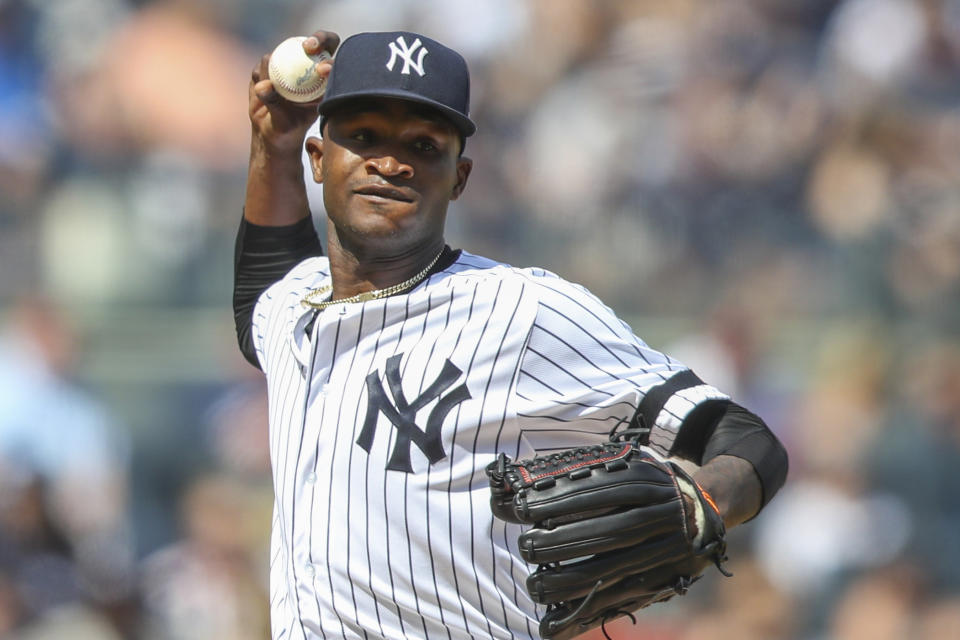 FILE - This is an Aug. 31, 2019, file photo showing New York Yankees pitcher Domingo German throwing to first in a pickoff attempt during the fifth inning of a baseball game against the Oakland Athletics, in New York. Yankees star pitcher Domingo Germán has been placed on administrative leave by Major League Baseball because of domestic violence. MLB did not give details in its statement Thursday, Sept. 19, 2019, but said the leave "may last up to seven days, barring an extension." (AP Photo/Mary Altaffer, File)