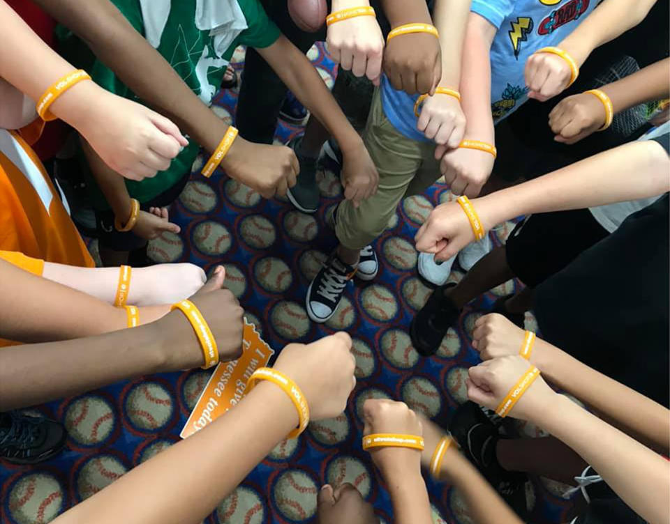 The boy's classmates show off their University of Tennessee wrist bands received in a care package from the college. Source: Facebook / Laura Snyder