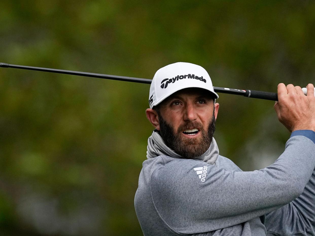 Dustin Johnson watches his tee shot at the 2022 Masters.