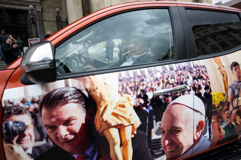 Members of the Roma community construct their own version of the popemobile to promote Pope Francis' upcoming visit to Budapest