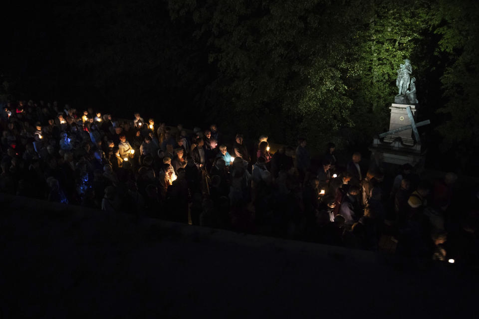 People with candles participate in a Stations of the Cross at the Jasna Gora Monastery, Poland's most revered Catholic shrine, in Czestochowa, Poland, Saturday, Sept. 23, 2023. As the ruling conservative Law and Justice party seeks to win an unprecedented third straight term in the Oct. 15 parliamentary election, it has sought to bolster its image as a defender of Christian values and traditional morality. Yet more and more Poles appear to be questioning their relationship with the Catholic church, and some cite its closeness to the government as a key reason. (AP Photo/Michal Dyjuk)