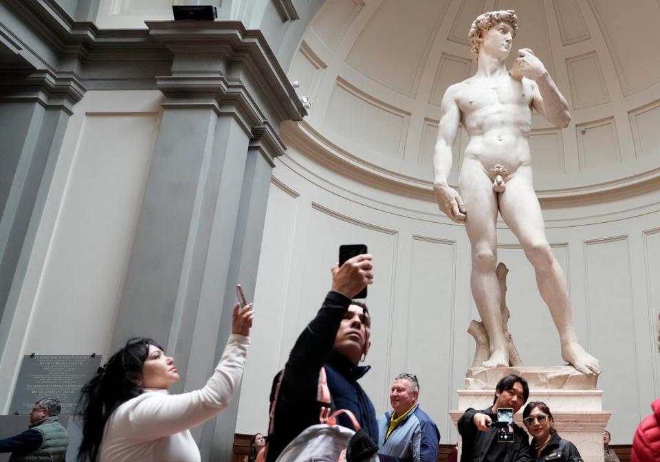 Tourists take photos in front of Michelangelo’s David statue in the Accademia Gallery in Florence, Italy (Copyright 2023 The Associated Press. All rights reserved)