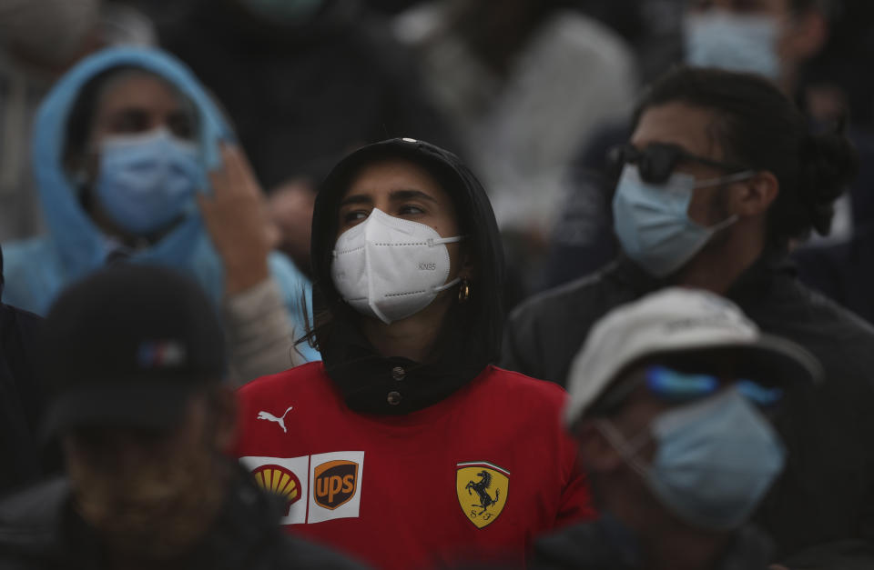 Fans wearing protective face masks watch the Formula One Portuguese Grand Prix at the Algarve International Circuit in Portimao, Portugal, Sunday, Oct. 25, 2020. (Jose Sena Goulao, Pool via AP)