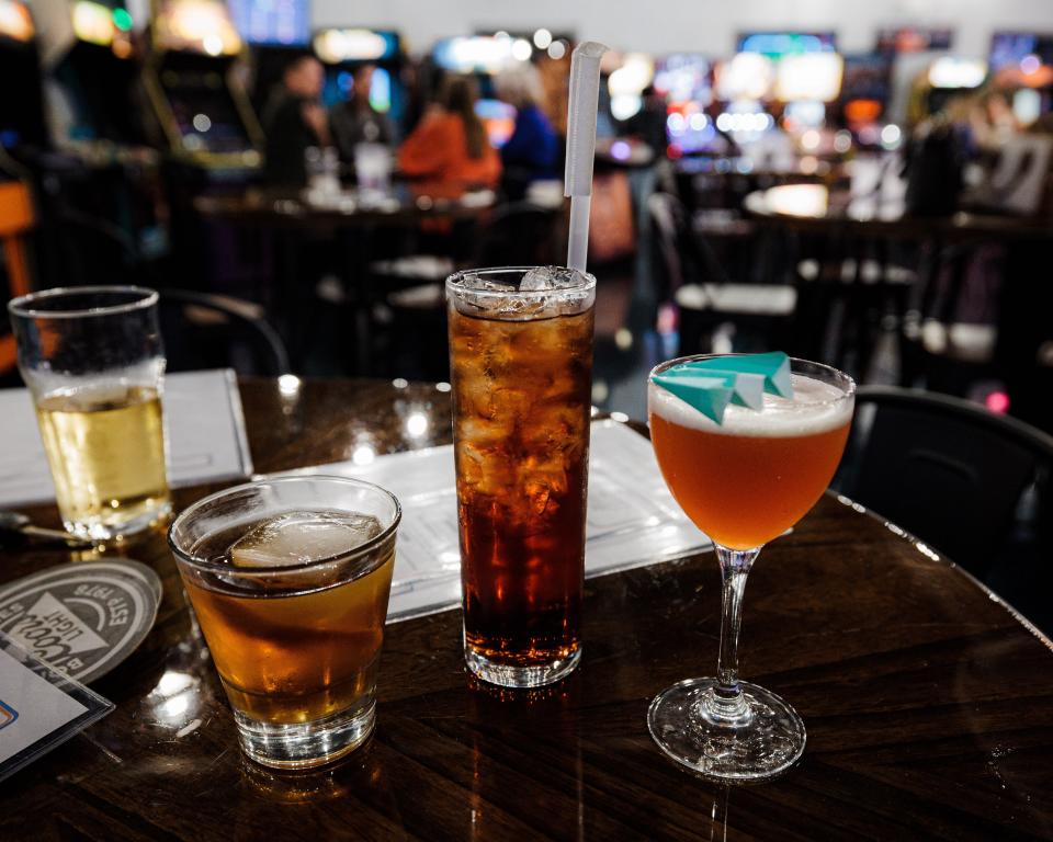 Remi's Arcade & Bistro's signature cocktails, (left to right) Remi's Smokey Old Fashioned, Singapore Sling and Paper Plane.