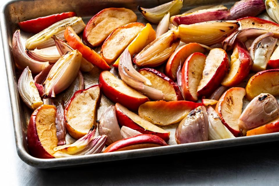 To start, you place wedges of sweet apple and shallot on a sheet pan, toss with a little oil and salt, and cook until they have become soft, sweet and beautifully browned (Scott Suchman/The Washington Post)