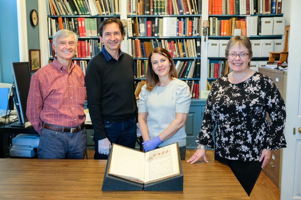 Left to right: historian Rick Geffken. Miguel Gleason of the Mexican Cultural Institute, librarian Dana Howell of the Monmouth County Historical Association and Bernadette Rogoff, Monmouth County Historical Association's director of collections, with 18th Century Volume “En El Nombre De Dios”
