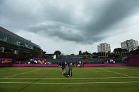 LONDON, ENGLAND - JULY 29: Members of the groundstaff remove the net on a court as rain delays play on Day 2 of the London 2012 Olympic Games at the All England Lawn Tennis and Croquet Club in Wimbledon on July 29, 2012 in London, England. (Photo by Ezra Shaw/Getty Images)