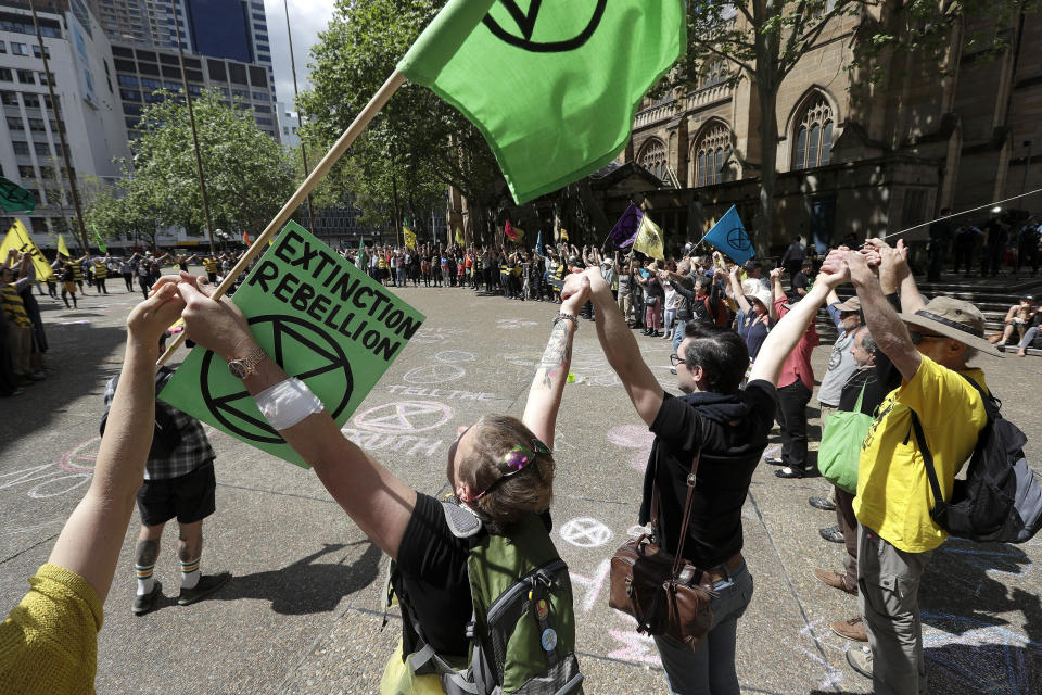 Climate change protestors from the Extinction Rebellion movement gather to demonstrate at Town Hall in Sydney, Tuesday, Oct. 8, 2019. In a series of protests also including Australian cities of Melbourne, Brisbane and Perth, protestors are demanding much more urgent action against climate change. (AP Photo/Rick Rycroft)