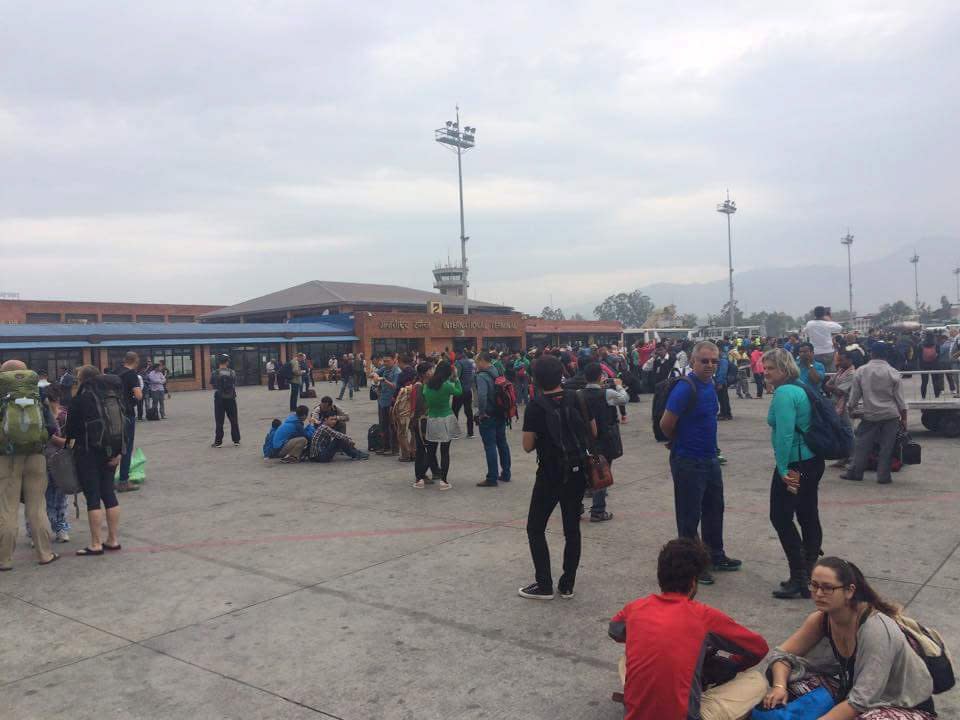 Handout shows people standing on the runway outside the International Terminal after a earthquake hit, at Tribhuvan International Airport, Kathmandu, Nepal