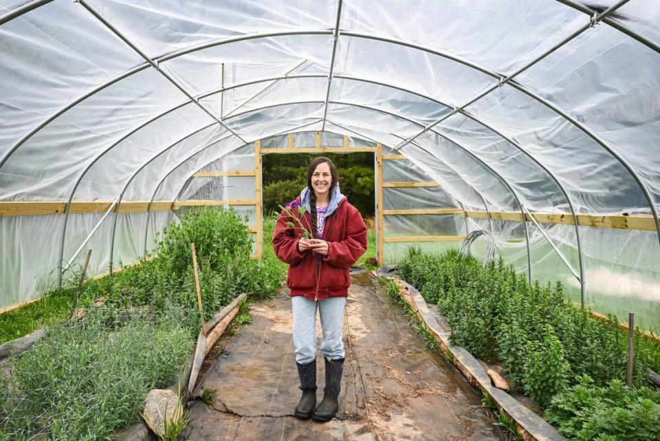 Julia Rogers stands inside a tunnel greenhouse where she and her husband grow the flowers offered for sale in bouquets. After Rogers’ husband returned from active duty in the military, they built a house on the site of Blackberry Ridge Farms, a century farm that has been in her family for over a hundred years. They began farming hemp and flowers, as well as offering their space for events and educational classes.