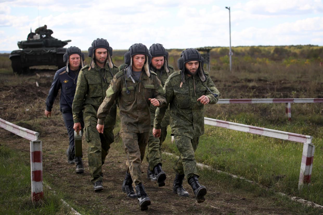 Recruits walk during a military training at a firing range in the Krasnodar region in southern Russia, Tuesday, Oct. 4, 2022.