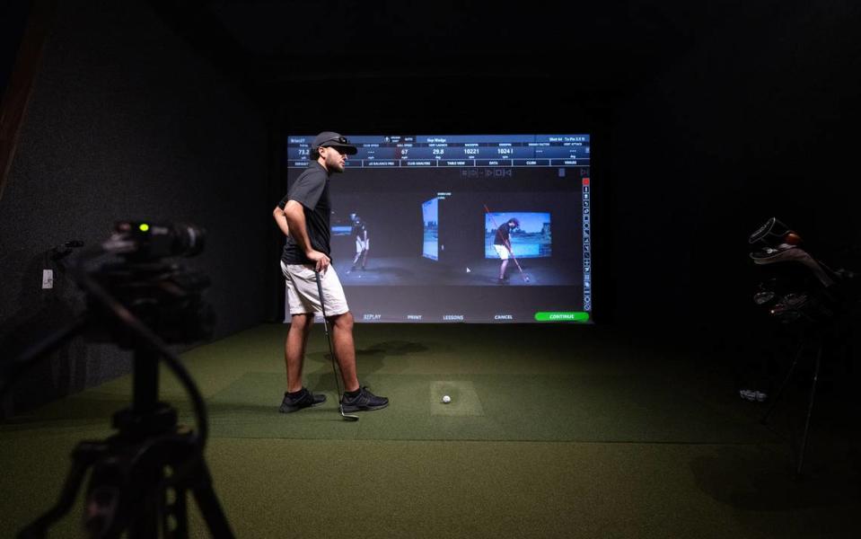 Rey Rosas uses video recording to analyze his swing with the help of a teaching professional at Swing Center Indoor Golf in Modesto, Calif., Wednesday, August 23, 2023.