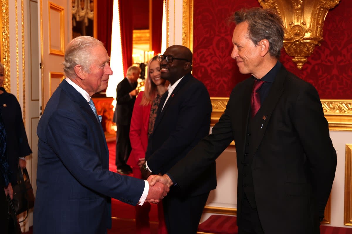 The Prince of Wales, now King Charles III, shakes hands with Richard E Grant (Tim P Whitby/PA) (PA Archive)