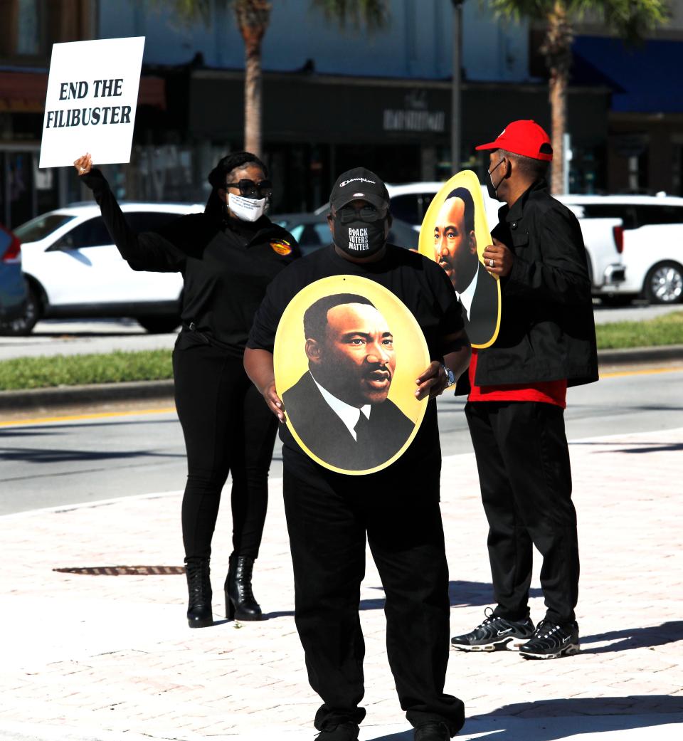 Protesters gather at the base of the International Speedway Boulevard bridge in Daytona Beach in support of the John Lewis Voting Rights Act. Rev. L. Ronald Durham, president of the Volusia County Democratic Black Caucus, said he hopes the rally can "energize those in Washington to get up and do something" about voting rights.