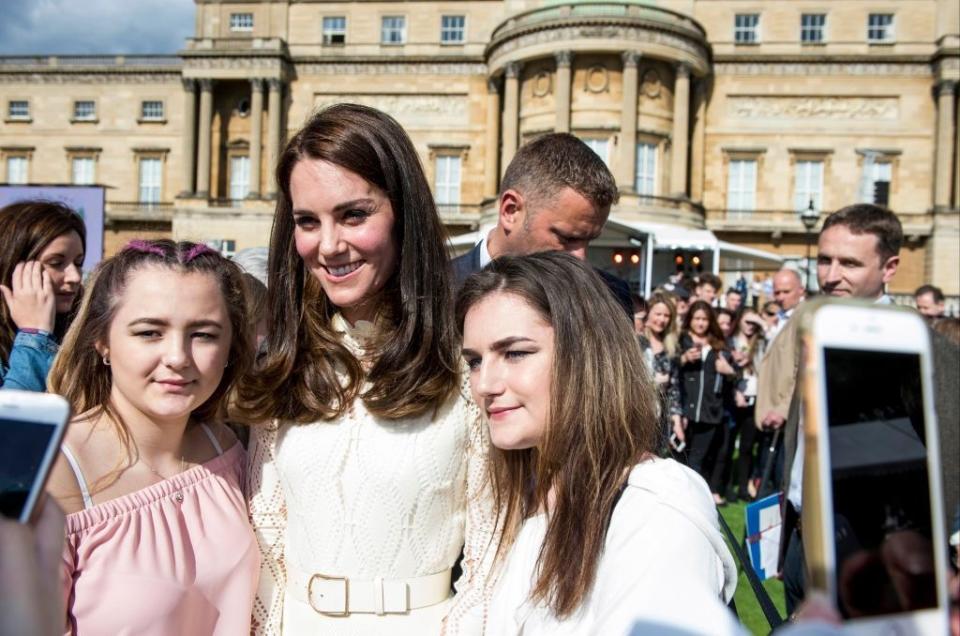 Kate Middleton poses for a photo with Buckingham Palace guests