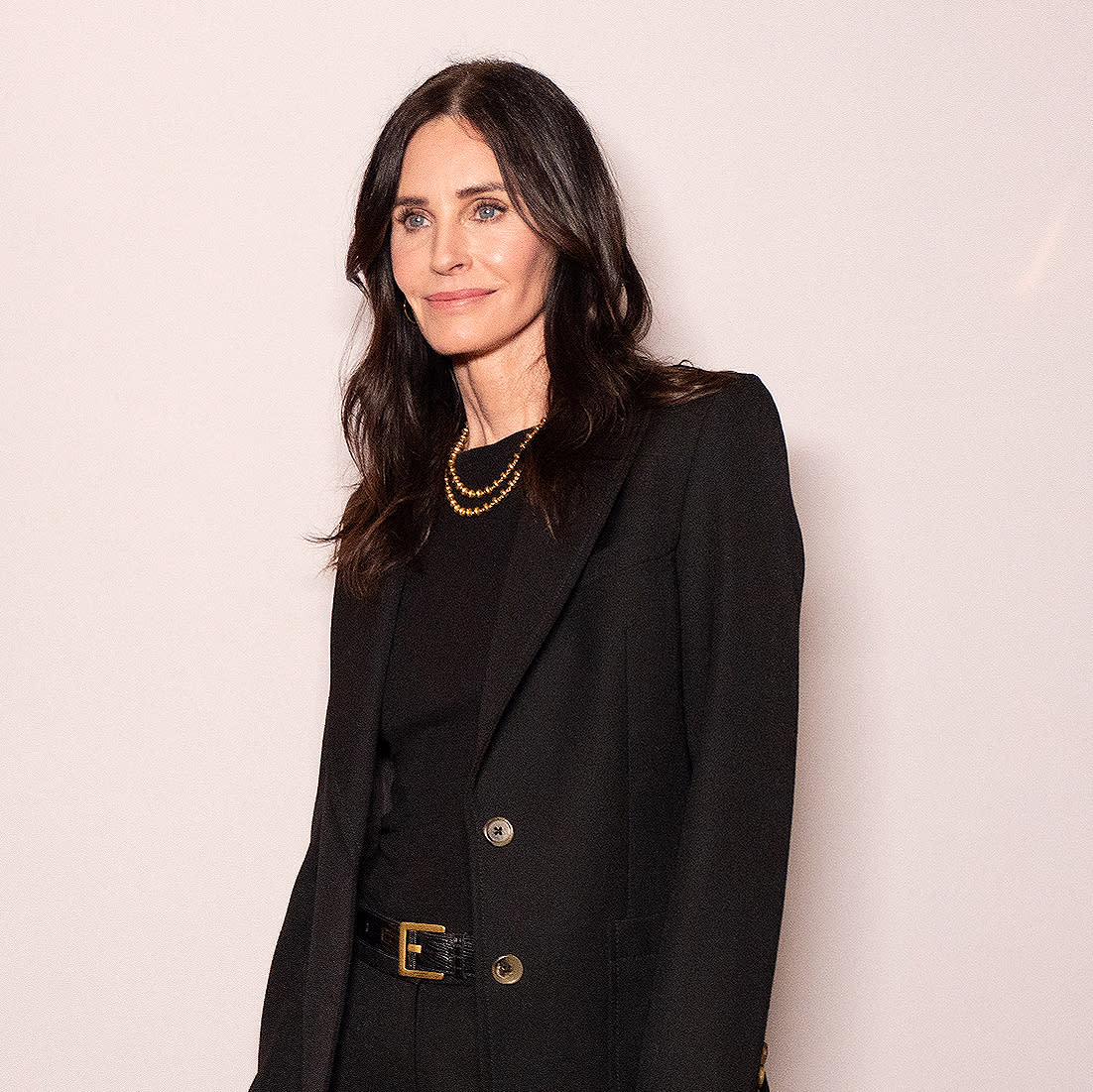  Courteney Cox in front of a step and repeat at Marie Claire's power play event. 