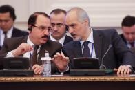 Bashar Jaafari, Syrian Ambassador to the UN and head of the Syrian delegation, right, speaks to a member of Syrian delegation during the talks on Syrian peace in Astana, Kazakhstan, Monday, Jan. 23, 2017. Syria talks brokered by Russia, Turkey and Iran aimed at bolstering a shaky cease-fire in place since last month opened on Monday in Kazakhstan, marking the first face-to-face meeting between the Damascus government representatives and rebel factions trying to overthrow it. The gathering is also the start of a new effort to end six years of carnage that has killed hundreds of thousands, displaced half of Syria’s population and sent millions of refugees to neighboring countries and Europe. (AP Photo/Sergei Grits)