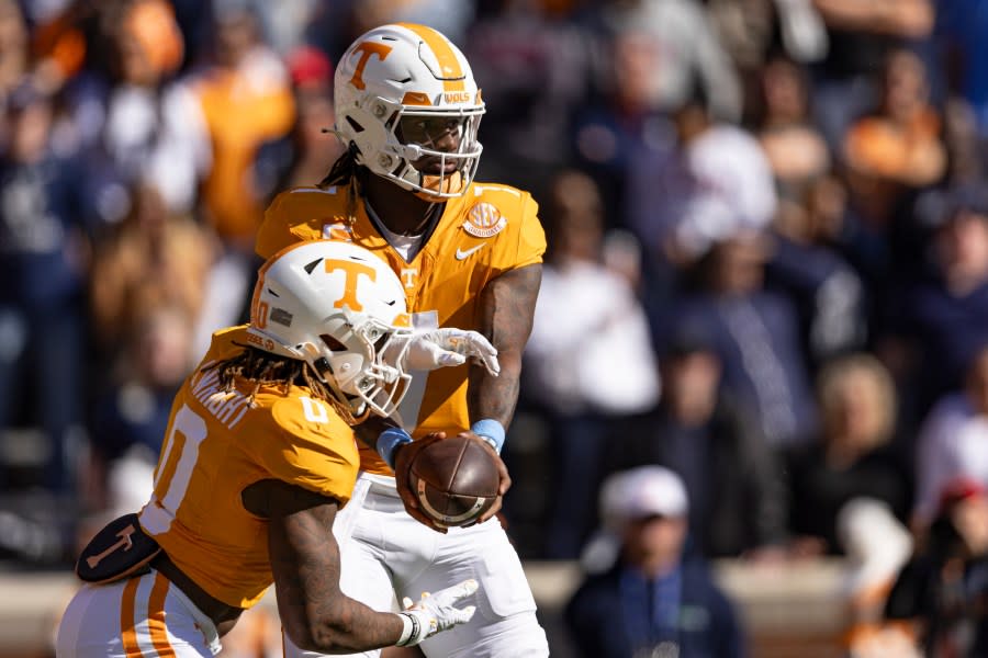 Tennessee quarterback Joe Milton III (7) hands the ball off to running back Jaylen Wright (0) during the first half of an NCAA college football game against UConn, Saturday, Nov. 4, 2023, in Knoxville, Tenn. (AP Photo/Wade Payne)