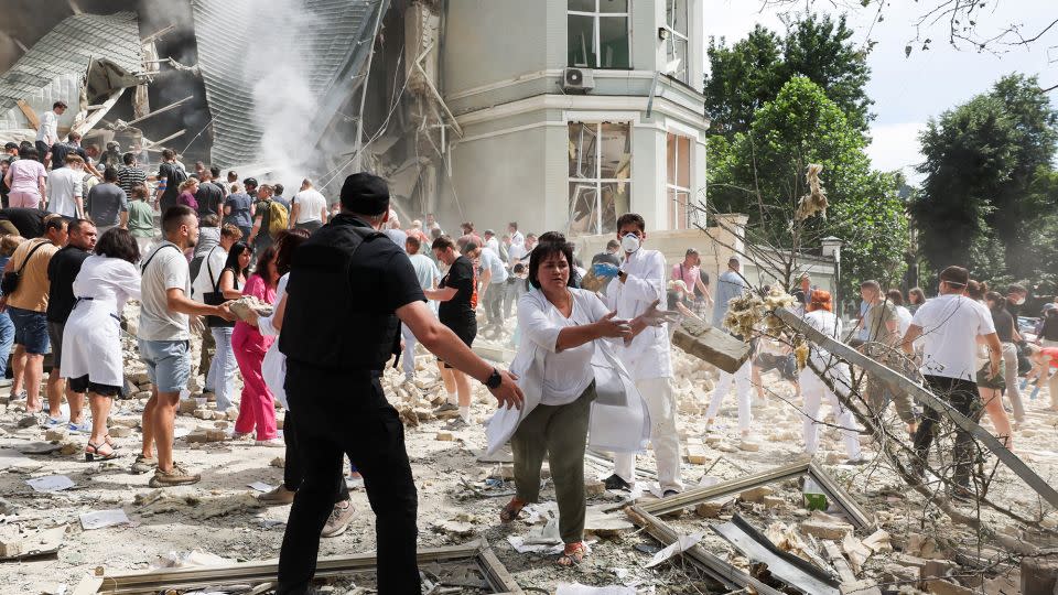 Medical staff and members of the community move rubble away from damaged areas at the hospital and search for survivors. - Gleb Garanich/Reuters