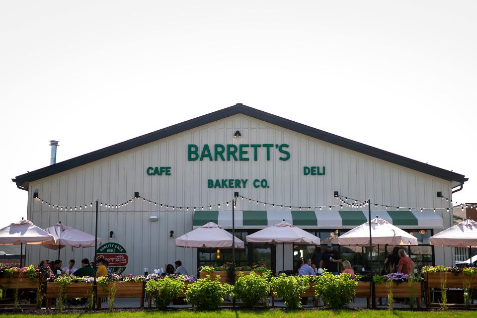 People dine outside on a patio at Barrett's Quality Eats in Coralville.