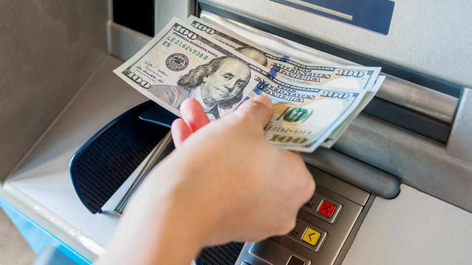 Woman hand taking money out of the ATM machine, fees, America, money, payment, avoid fees, bills, debt