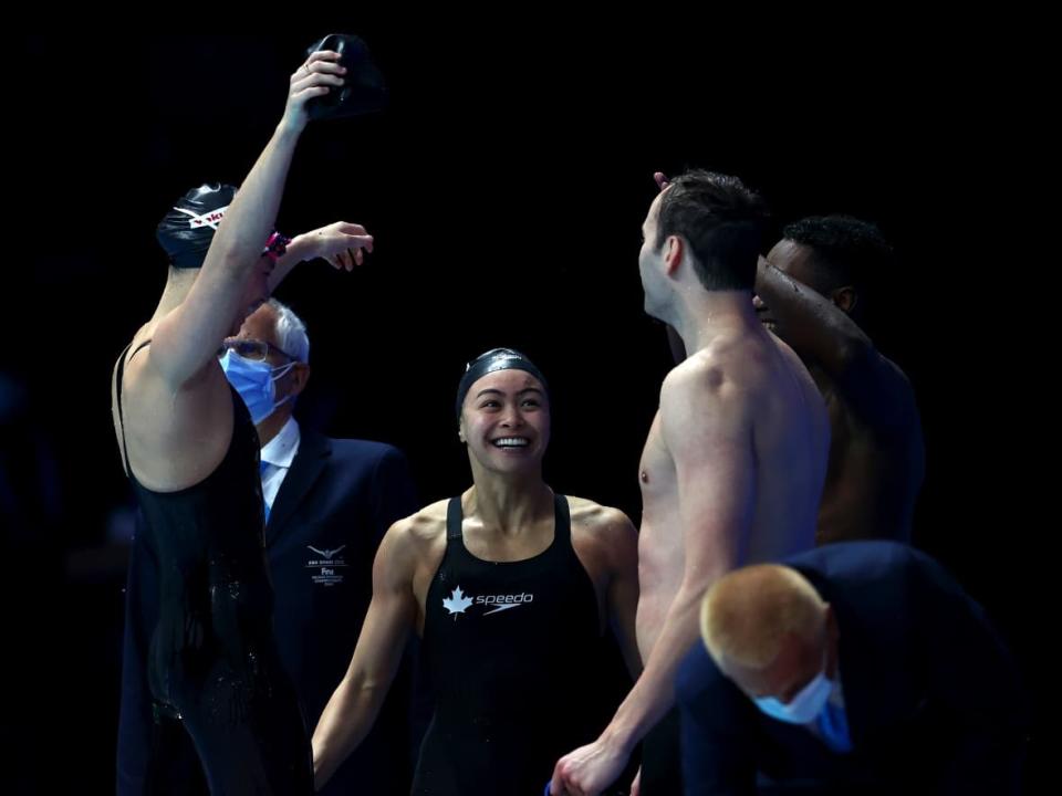 Canadian swimmers celebrate their gold-medal victory in the mixed 4x50m freestyle relay final on Friday at the FINA world swimming short-course championships in Abu Dhabi. (Clive Rose/Getty Images - image credit)