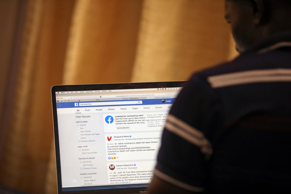 A man opens the Facebook page on his computer to fact check coronavirus disease (COVID-19) information, in Abuja, Nigeria March 19, 2020. Picture taken March 19, 2020. REUTERS/Afolabi Sotunde