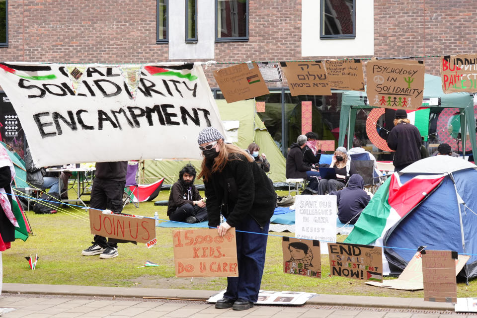 A student adjusts a sign at an encampment on the grounds of Newcastle University, protesting against the war in Gaza,  May 2, 2024. Students at universities in Leeds, Newcastle and Bristol have set up tents outside university buildings, replicating the nationwide campus demonstrations that started in the U.S. / Credit: Owen Humphreys/PA Images via Getty Images