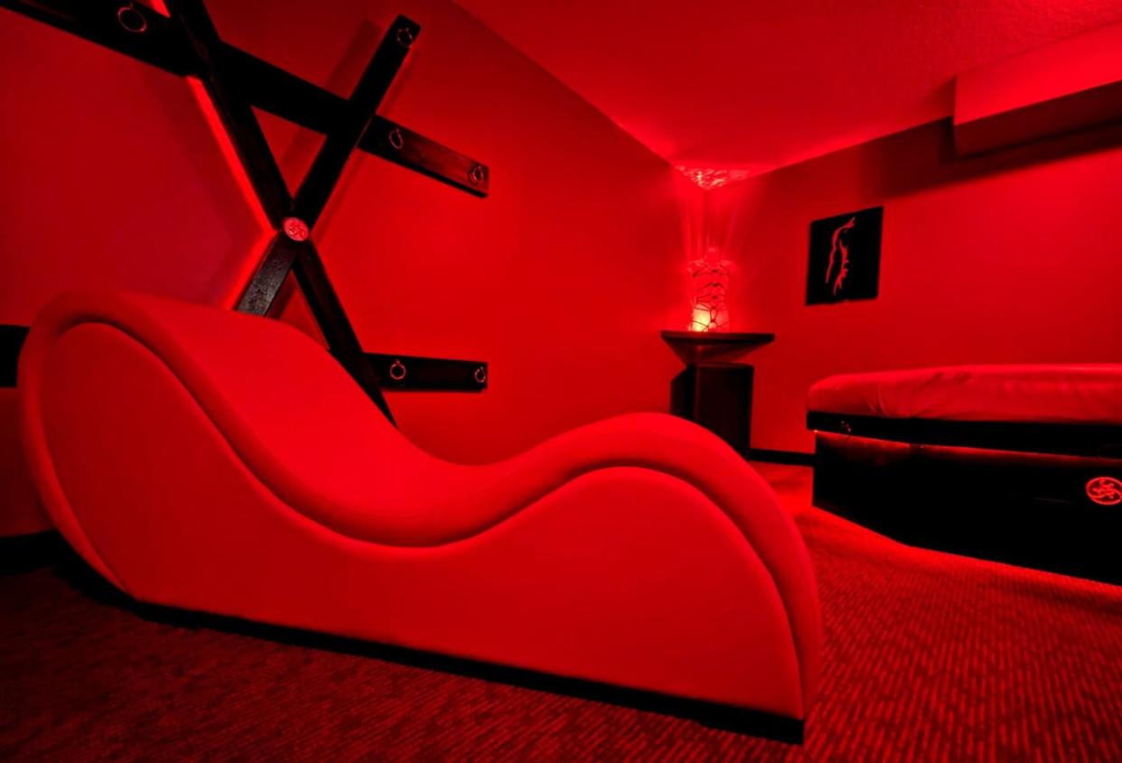 Sex party gatherings can continue to take place at a Calgary home but not under the branding of Club Ménage, a judge has ruled. Pictured is one of the rooms in the home at the centre of the court case.  (@menageyyc/X - image credit)