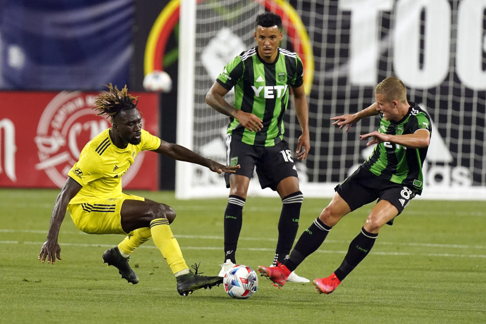 Nashville SC forward C.J. Sapong, left, battles for the ball with Austin FC midfielder Alexander Ring (8) and defender Julio Cascante (18) during the first half of an MLS soccer match, Sunday, May 23, 2021, in Nashville, Tenn. (AP Photo/Mark Humphrey)