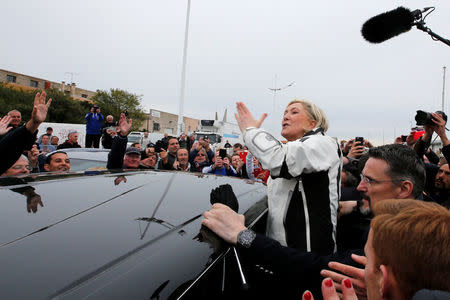 Marine Le Pen (C), French National Front (FN) political party candidate for French 2017 presidential election, waves to supporters as she leaves after an excursion on a fishing boat during a campaign visit to the port in Grau-du-Roi, France, April 27, 2017. REUTERS/Jean-Paul Pelissier