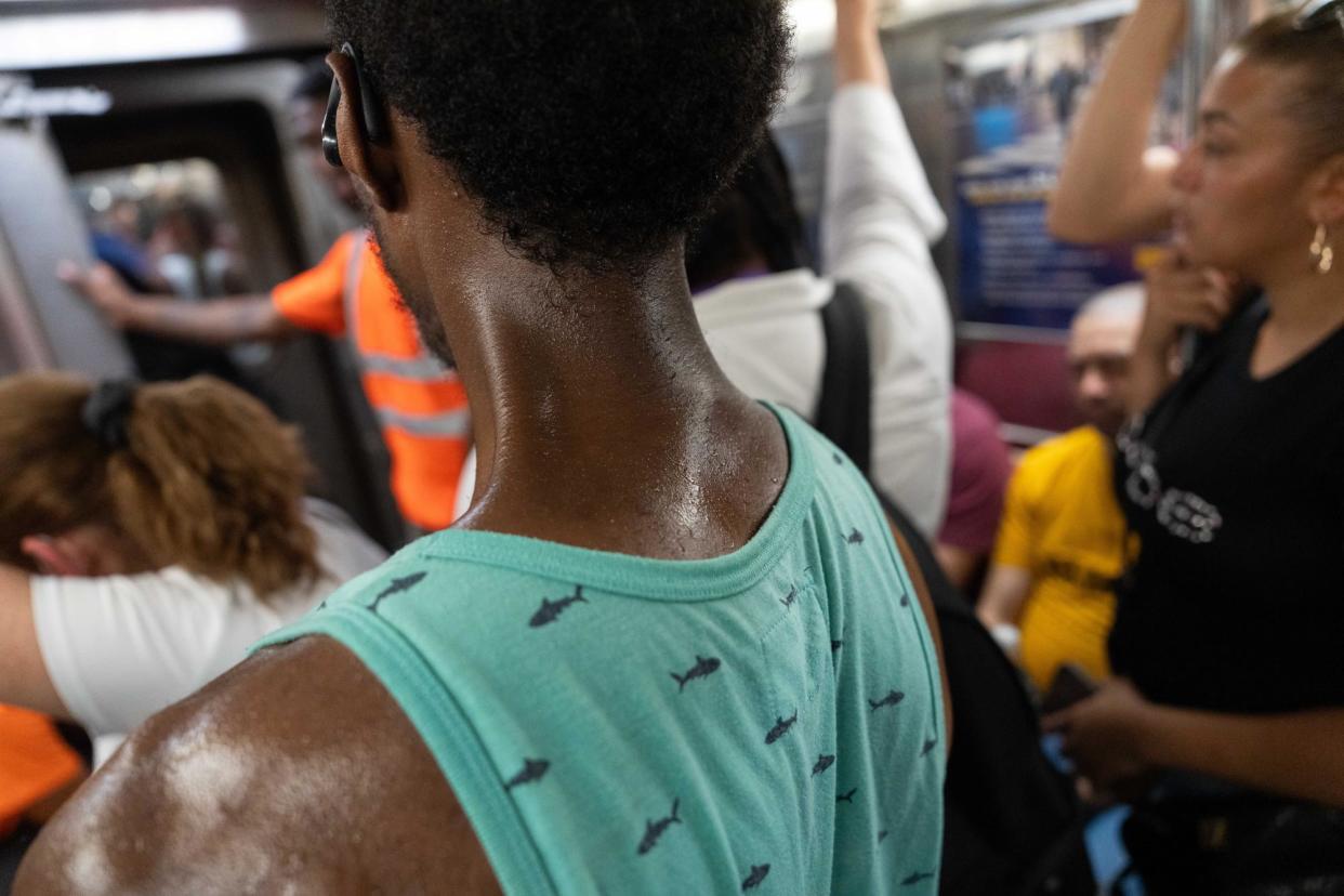 <span>A person sweats in the subway during a heatwave in New York on 16 July 2024.</span><span>Photograph: Adam Gray/Getty Images</span>