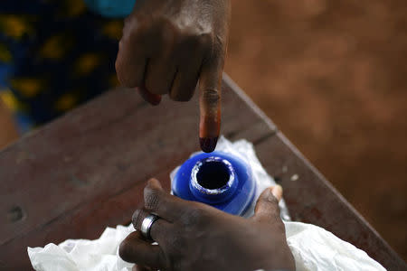 A voter's finger is marked with ink at a polling station during a presidential run-off in Freetown, Sierra Leone March 31, 2018. REUTERS/Olivia Acland