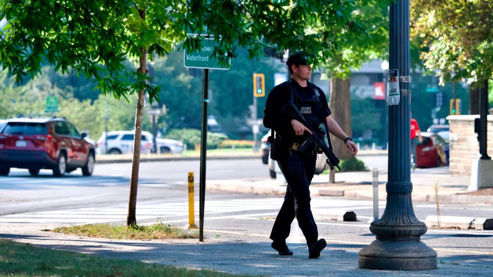 A US Secret Service officer searches for Christopher Haynes, who escaped custody while at George Washington University Hospital on Wednesday. - Craig Hudson/The Washington Post/AP