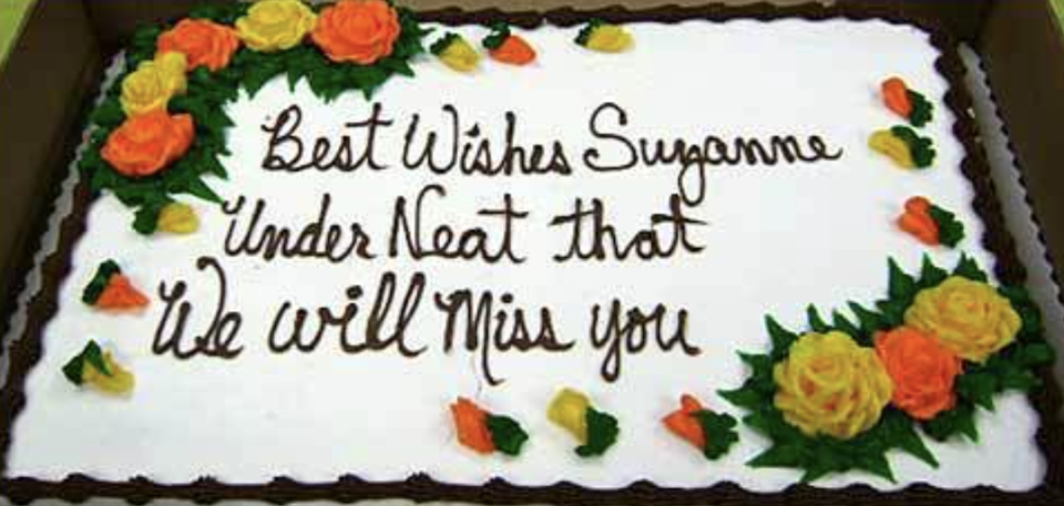 Cake with the message "Best Wishes Suzanne Under Neat that We will Miss you" indicating a misunderstanding for "write that underneath."